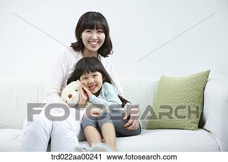 The woman and girl sitting with the teddy bear View Large Photo Image Stock Image - The woman and girl sitting with the teddy bear. Fotosearch