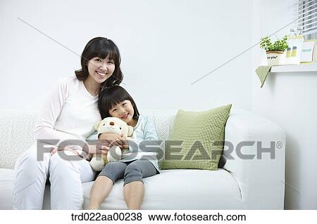 The woman and girl sitting with the teddy bear View Large Photo Image Stock Photo - The woman and girl sitting with the teddy bear. Fotosearch