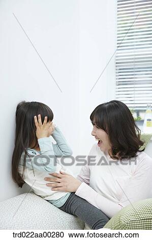 The woman and girl smiling at each other View Large Photo Image Stock Image - The woman and girl smiling at each other. Fotosearch
