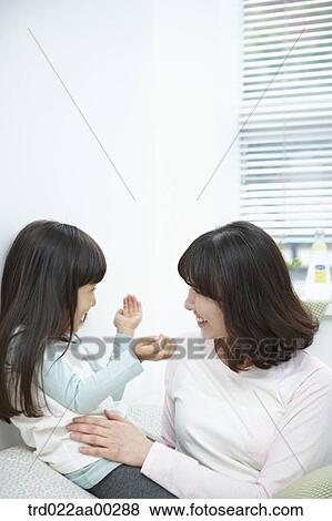 The woman and girl smiling at each other View Large Photo Image Stock Photo - The woman and girl smiling at each other. Fotosearch