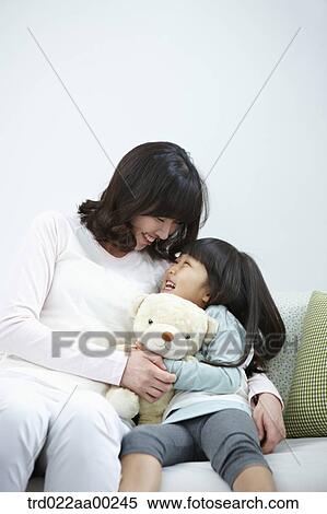 The woman and girl smiling at each other View Large Photo Image Stock Photography - The woman and girl smiling at each other. Fotosearch