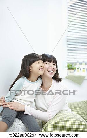Stock Photo - The woman and girl smiling together. Fotosearch