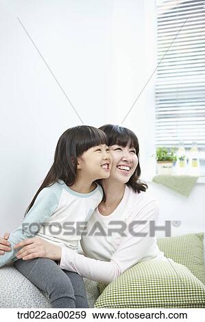 Stock Photo - The woman and girl smiling together. Fotosearch