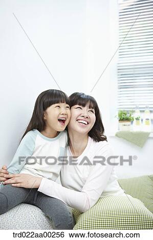 Stock Photograph - The woman and girl smiling together. Fotosearch