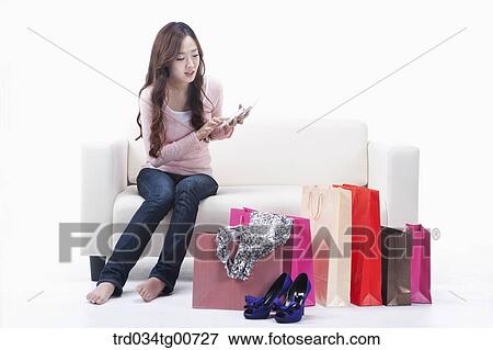 The woman calculating her shopping items View Large Photo Image Stock Photo - The woman calculating her shopping items. Fotosearch
