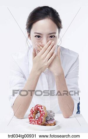 The woman covering her mouth with hands View Large Photo Image Stock Image - The woman covering her mouth with hands. Fotosearch