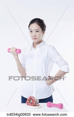 The woman exercising with the dumbbell View Large Photo Image Stock Image - The woman exercising with the dumbbell . Fotosearch