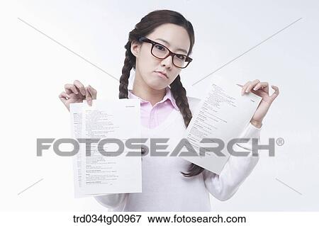 The woman holding the sheets of exam View Large Photo Image Stock Photo - The woman holding the sheets of exam . Fotosearch