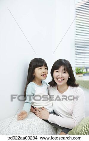 The woman hugging the girl with big smile View Large Photo Image Picture - The woman hugging the girl with big smile. Fotosearch