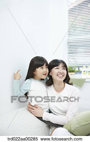 Stock Photography - The woman hugging the girl with big smile. Fotosearch