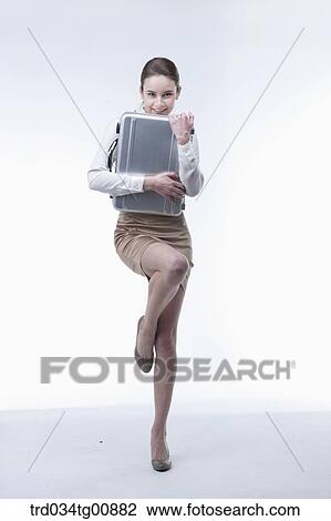 The woman hugging the metal suitcase View Large Photo Image Stock Image - The woman hugging the metal suitcase. Fotosearch