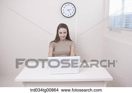 The woman looking at the laptop View Large Photo Image Picture - The woman looking at the laptop . Fotosearch