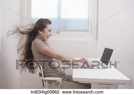 The woman looking at the laptop with windblown hair View Large Photo Image Stock Image - The woman looking at the laptop with windblown hair. Fotosearch