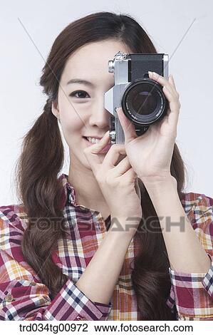 The woman looking through the camera View Large Photo Image Stock Image - The woman looking through the camera. Fotosearch