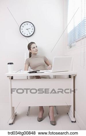 The woman looking through the window in the office View Large Photo Image Stock Photo - The woman looking through the window in the office. Fotosearch