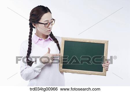 The woman pointing the black board View Large Photo Image Stock Photograph - The woman pointing the black board. Fotosearch