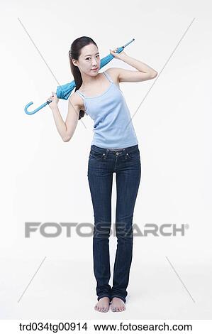 The woman stretching with blue umbrella View Large Photo Image Picture - The woman stretching with blue umbrella. Fotosearch