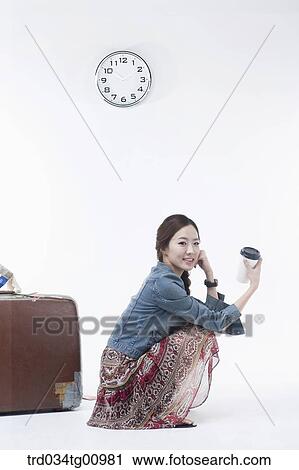 The woman waiting with a cup of coffee and suit case View Large Photo Image Stock Image - The woman waiting with a cup of coffee and suit case. Fotosearch