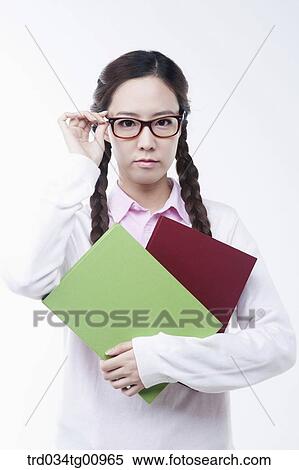 The woman wearing glasses with books View Large Photo Image Stock Photography - The woman wearing glasses with books. Fotosearch