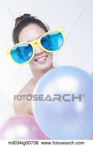 The woman wearing party sunglasses with colorful balloons View Large Photo Image Stock Photo - The woman wearing party sunglasses with colorful balloons. Fotosearch