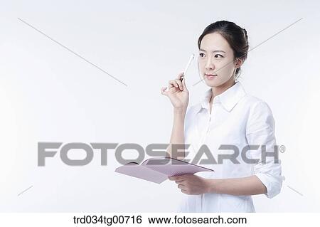 The woman with a pen and notebook View Large Photo Image Stock Photograph - The woman with a pen and notebook. Fotosearch