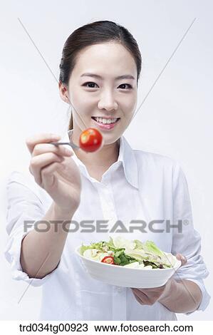 Stock Image - The woman with dish of salad. Fotosearch