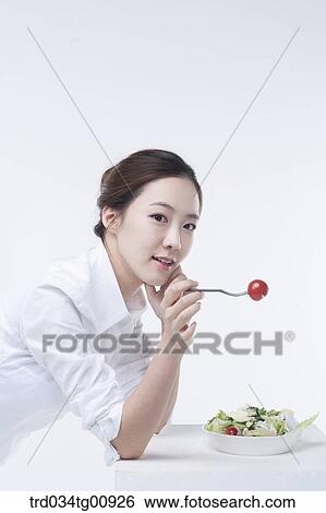 Stock Photograph - The woman with dish of salad. Fotosearch