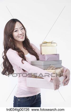 The woman with piled gift boxes View Large Photo Image Stock Photograph - The woman with piled gift boxes. Fotosearch