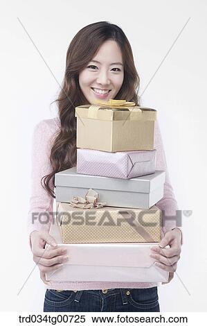 Stock Photography - The woman with piled gift boxes. Fotosearch