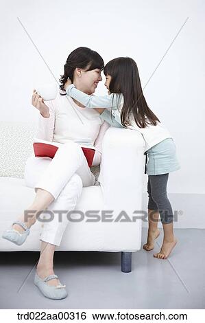 The woman with the cup of coffee and book facing the girl View Large Photo Image Stock Photograph - The woman with the cup of coffee and book facing the girl . Fotosearch