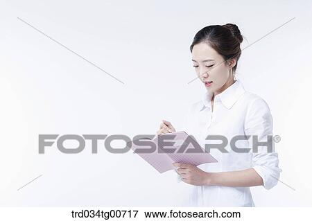 The woman writing on the notebook View Large Photo Image Stock Photo - The woman writing on the notebook. Fotosearch