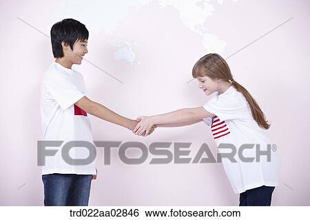 A Chinese student and American student shaking hands together View Large Photo Image Stock Photograph - A Chinese student and American student shaking hands together. Fotosearch