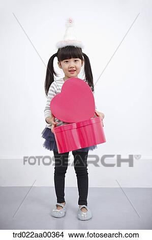 A girl holding red heart box View Large Photo Image Picture - A girl holding red heart box. Fotosearch