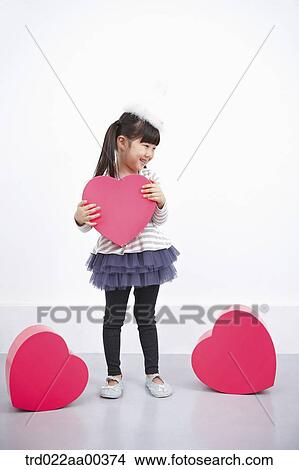 Picture - A girl holding red heart box. Fotosearch