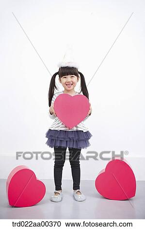 A girl holding red heart box View Large Photo Image Stock Image - A girl holding red heart box. Fotosearch