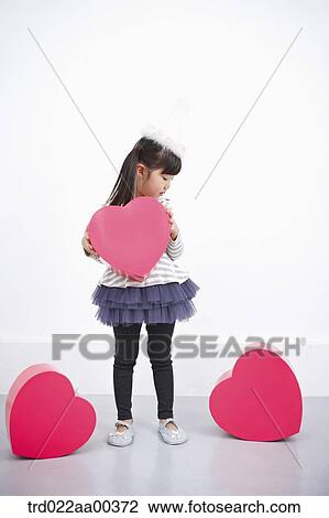 A girl holding red heart box View Large Photo Image Stock Image - A girl holding red heart box. Fotosearch