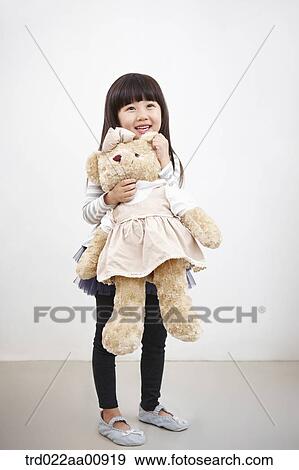 A girl hugging teddy bear View Large Photo Image Stock Photo - A girl hugging teddy bear . Fotosearch