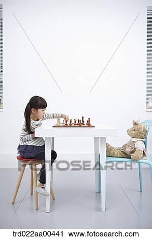 A girl playing chess game with teddy bear View Large Photo Image Stock Image - A girl playing chess game with teddy bear. Fotosearch