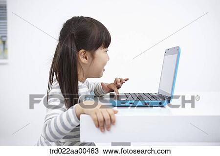 A girl typing on the laptop View Large Photo Image Stock Image - A girl typing on the laptop . Fotosearch