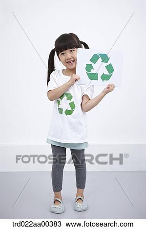 Stock Image - A girl wearing recycling shirt with recycling mark . Fotosearch