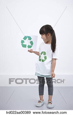 Stock Photo - A girl wearing recycling shirt with recycling mark . Fotosearch