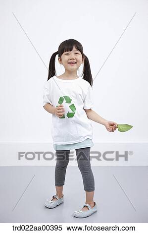 Stock Photography - A girl wearing recycling shirt with green leaf. Fotosearch