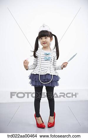 A girl with accessories and red shoes on View Large Photo Image Picture - A girl with accessories and red shoes on . Fotosearch