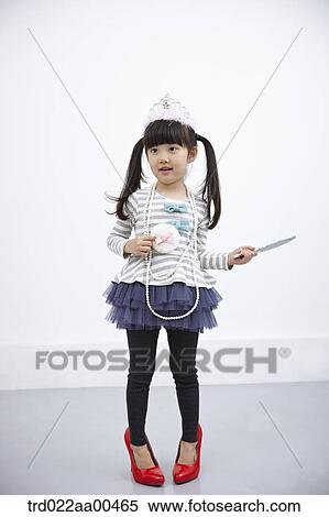 A girl with accessories and red shoes on View Large Photo Image Stock Photography - A girl with accessories and red shoes on . Fotosearch