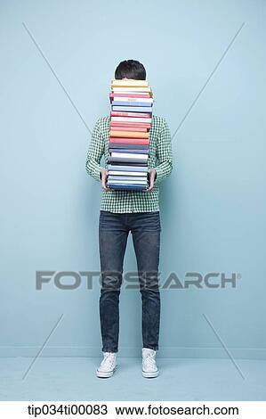 Stock Image - A man carrying the pile of books. Fotosearch