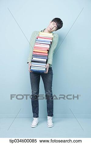 Stock Photography - A man carrying the pile of books. Fotosearch