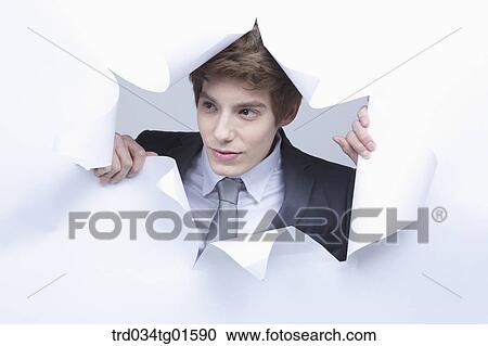 Stock Image - A man from the torn paper. Fotosearch