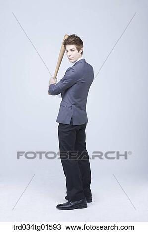 A man holding the bat View Large Photo Image Stock Image - A man holding the bat . Fotosearch