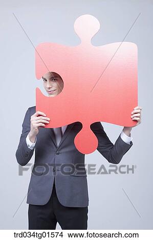 A man holding the big piece of red puzzle View Large Photo Image Picture - A man holding the big piece of red puzzle. Fotosearch