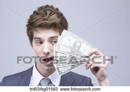 A man holding the money View Large Photo Image Stock Image - A man holding the money. Fotosearch